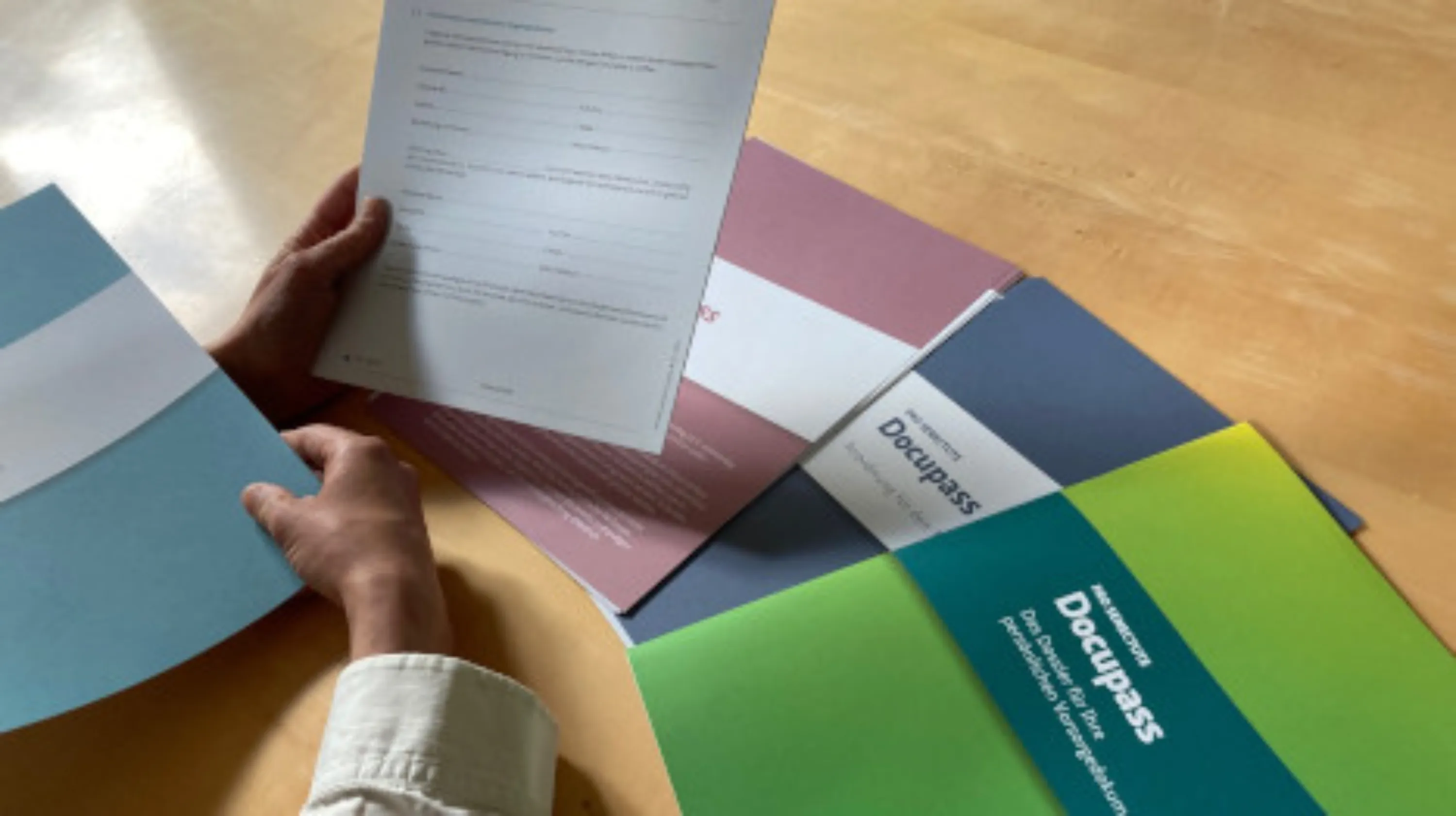 Eine ältere Person füllt den Docupass aus.